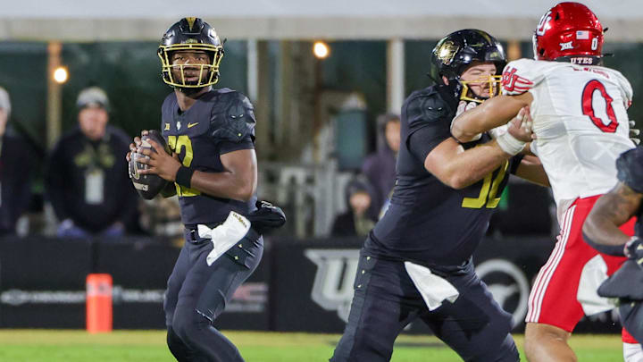 Nov 29, 2024; Orlando, Florida, USA; UCF Knights quarterback EJ Colson (12) looks to pass during the second quarter against the Utah Utes at FBC Mortgage Stadium. Mandatory Credit: Mike Watters-Imagn Images