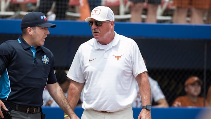 Texas Longhorns head coach Mike White talks to the home plate umpire in the sixth inning against the Tennessee Lady Volunteers.