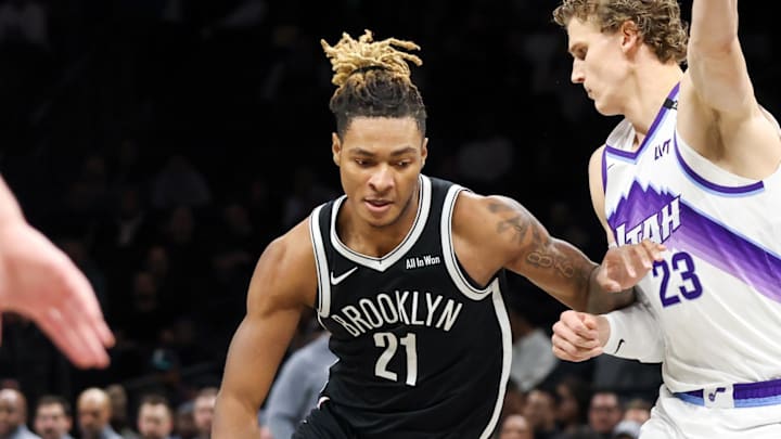 Dec 4, 2025; Brooklyn, New York, USA; Brooklyn Nets forward Noah Clowney (21) moves the ball past Utah Jazz forward Lauri Markkanen (23) during the first quarter at Barclays Center. Mandatory Credit: Tom Horak-Imagn Images