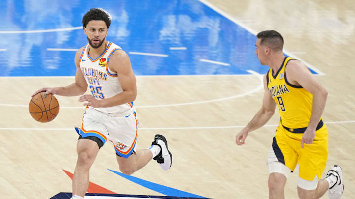 Jun 5, 2025; Oklahoma City, Oklahoma, USA; Oklahoma City Thunder guard Ajay Mitchell (25) dribbles the ball against Indiana Pacers guard T.J. McConnell (9) during the first quarter in game one of the 2025 NBA Finals at Paycom Center. Mandatory Credit: Kyle Terada-Imagn Images