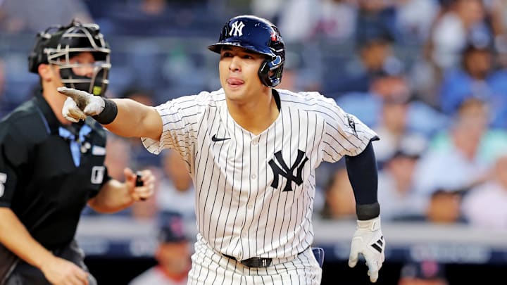 Sep 30, 2025; Bronx, New York, USA; New York Yankees shortstop Anthony Volpe (11) hits a solo home run during the first inning against the Boston Red Sox during game one of the Wildcard round for the 2025 MLB playoffs at Yankee Stadium. Mandatory Credit: Brad Penner-Imagn Images