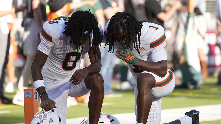 Sep 4, 2026; Stanford, California, USA; Miami Hurricanes wide receiver Vandrevius Jacobs (8) and
wide receiver Malachi Toney (1) take a knee in the endzone prior to kick off against the Stanford Cardinal at Stanford Stadium. Mandatory Credit: Stan Szeto-Imagn Images Sep 4, 2026; Stanford, California, USA; Miami Hurricanes wide receiver Vandrevius Jacobs (8) and
wide receiver Malachi Toney (1) take a knee in the endzone prior to kick off against the Stanford Cardinal at Stanford Stadium. Mandatory Credit: Stan Szeto-Imagn Images
