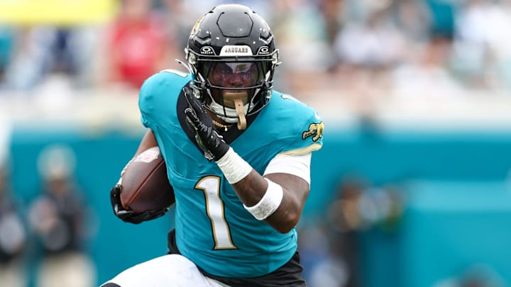 Oct 6, 2024; Jacksonville, Florida, USA; Jacksonville Jaguars running back Travis Etienne Jr. (1) runs with the ball against the Indianapolis Colts in the first quarter at EverBank Stadium. Mandatory Credit: Nathan Ray Seebeck-Imagn Images