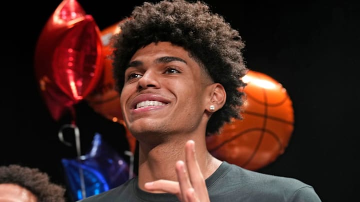 Basketball player NoNo Brown signs with Western New Mexico, left, and Koa Peat, signs with the University of Arizona during National Signing Day at Perry High School in Gilbert, Arizona on April 16, 2025.