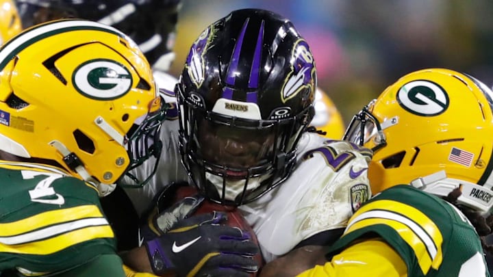 Ravens running back Derrick Henry (22) runs against Green Bay Packers linebacker Quay Walker (7) and safety Xavier McKinney. Ravens running back Derrick Henry (22) runs against Green Bay Packers linebacker Quay Walker (7) and safety Xavier McKinney.