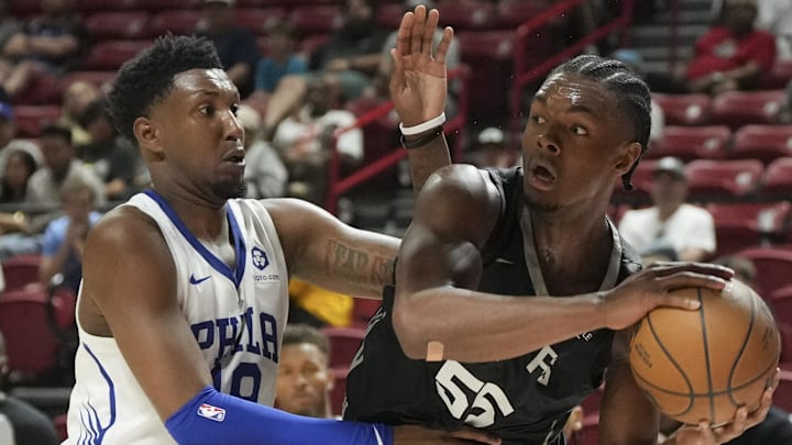 Jul 10, 2025; Las Vegas, NV, USA; San Antonio Spurs guard/forward Harrison Ingram (55) looks to pass against Philadelphia 76ers forward Justin Edwards (19) in the third quarter of their game at Thomas & Mack Center. Mandatory Credit: Candice Ward-Imagn Images