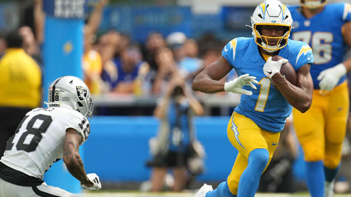 Sep 8, 2024; Inglewood, California, USA; Los Angeles Chargers wide receiver Quentin Johnston (1) carries the ball against Las Vegas Raiders cornerback Jack Jones (18) in the second half at SoFi Stadium. Mandatory Credit: Kirby Lee-Imagn Images