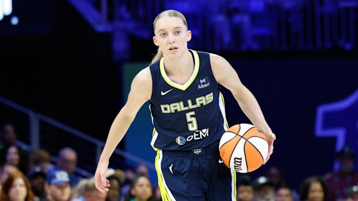 Jul 16, 2025; Arlington, Texas, USA; Dallas Wings guard Paige Bueckers (5) controls the ball against Las Vegas Aces guard Jackie Young (0) during the second half at College Park Center. Mandatory Credit: Chris Jones-Imagn Images