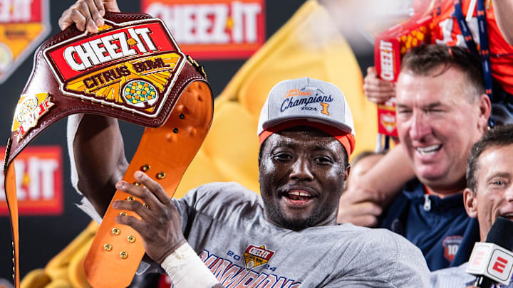 Dec 31, 2024; Orlando, FL, USA; Illinois Fighting Illini running back Josh McCray (6) celebrates winning the MVP after the game against the South Carolina Gamecocks at Camping World Stadium. Mandatory Credit: Jeremy Reper-Imagn Images