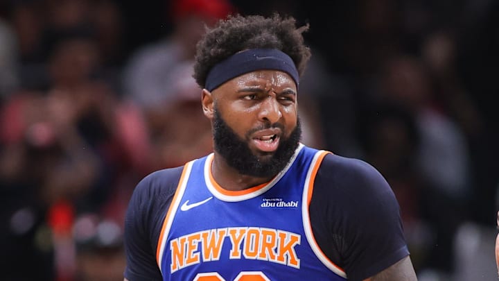 Apr 30, 2026; Atlanta, Georgia, USA; New York Knicks center Mitchell Robinson (23) is restrained by assistant coach Rick Brunson against the Atlanta Hawks in the second quarter during game six of the first round of the 2026 NBA Playoffs at State Farm Arena. Mandatory Credit: Brett Davis-Imagn Images