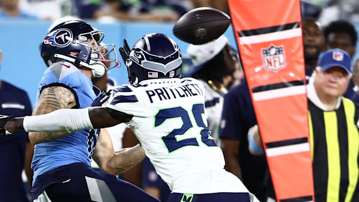 Aug 17, 2024; Nashville, Tennessee, USA; Tennessee Titans wide receiver Mason Kinsey (12) and Seattle Seahawks cornerback Nehemiah Pritchett (28) in the fourth quarter at Nissan Stadium. Mandatory Credit: Casey Gower-Imagn Images