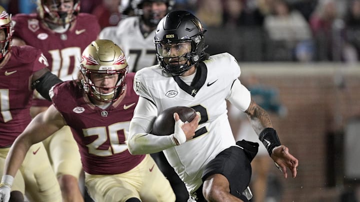 Nov 1, 2025; Tallahassee, Florida, USA; Wake Forest Demon Deacons quarterback Robby Ashford (2) runs the ball past Florida State Seminoles linebacker Blake Nichelson (20) during the first quarter at Doak S. Campbell Stadium. Mandatory Credit: Melina Myers-Imagn Images