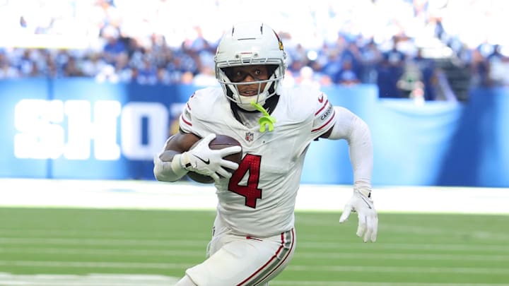 Oct 12, 2025; Indianapolis, Indiana, USA; Arizona Cardinals wide receiver Greg Dortch (4) carries the ball for a touchdown against the Arizona Cardinals during the third quarter of the game at Lucas Oil Stadium. Mandatory Credit: Trevor Ruszkowski-Imagn Images