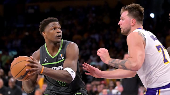 Apr 19, 2025; Los Angeles, California, USA; Minnesota Timberwolves guard Anthony Edwards (5) is defended by Los Angeles Lakers guard Luka Doncic (77) in the second half at Crypto.com Arena. Mandatory Credit: Jayne Kamin-Oncea-Imagn Images