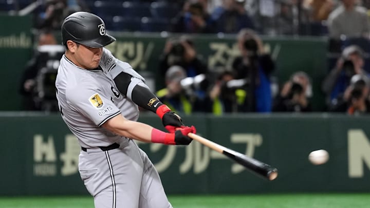 Mar 16, 2025; Bunkyo, Tokyo, Japan; Yomiuri Giants first baseman Kazuma Okamoto (25) hits a single against the Chicago Cubs during the second inning at Tokyo Dome. Mandatory Credit: Darren Yamashita-Imagn Images