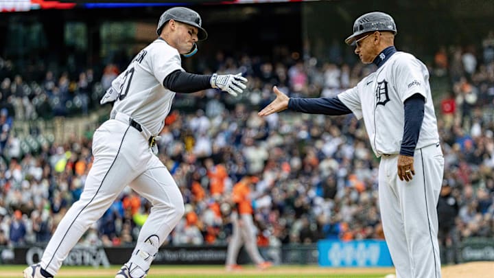 Apr 26, 2025; Detroit, Michigan, USA; Detroit Tigers first base Spencer Torkelson (20) runs the bases after hitting a solo home run against Baltimore Orioles pitcher Matt Bowman (51) and slaps hands with third base coach Joey Cora (56)during game one of a double header at Comerica Park. 