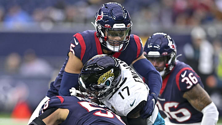 Jan 1, 2023; Houston, Texas, USA;  Houston Texans safety Jalen Pitre (5) and linebacker Christian Kirksey (58) tackle Jacksonville Jaguars tight end Evan Engram (17) during the third quarter at NRG Stadium. Mandatory Credit: Maria Lysaker-Imagn Images