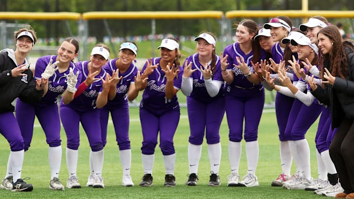 The Sunset softball team is all smiles after Thursday’s 3-2 eight-inning win over McNary.