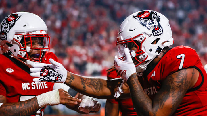 Nov 21, 2025; Raleigh, North Carolina, USA;  NC State Wolfpack tight end Justin Joly (7) celebrates his touchdown to win the game during the second half of the game against Florida State Seminoles at Carter-Finley Stadium. Mandatory Credit: Jaylynn Nash-Imagn Images