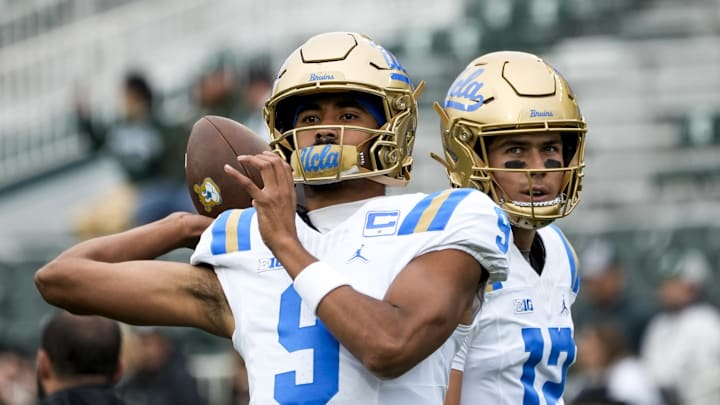 Oct 11, 2025; East Lansing, Michigan, USA; UCLA quarterback Nico Iamaleava (9) throws the ball during warmups while UCLA Bruins quarterback Luke Duncan (12) watches at Spartan Stadium. Mandatory Credit: Brendan Mullin-Imagn Images Oct 11, 2025; East Lansing, Michigan, USA; UCLA quarterback Nico Iamaleava (9) throws the ball during warmups while UCLA Bruins quarterback Luke Duncan (12) watches at Spartan Stadium. Mandatory Credit: Brendan Mullin-Imagn Images