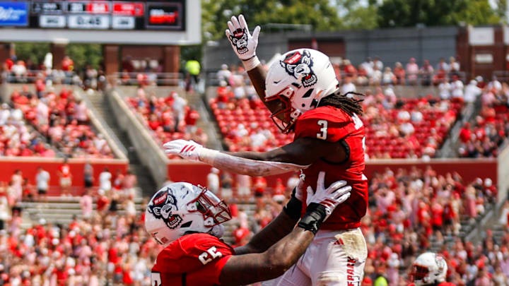 Sep 6, 2025; Raleigh, North Carolina, USA; North Carolina State Wolfpack running back Hollywood Smothers (3), and offensive lineman Matt McCabe (66) celebrate a touchdown during the second half of the game against Virginia Cavaliers at Carter-Finley Stadium. Mandatory Credit: Jaylynn Nash-Imagn Images