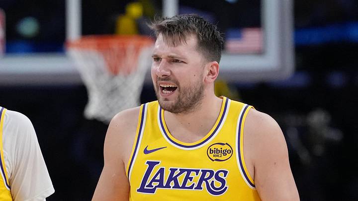 Jan 15, 2026; Los Angeles, California, USA; Los Angeles Lakers forward Jake LaRavia (12) and guard Luka Doncic (77) react against the Charlotte Hornets in the second half at Crypto.com Arena. Mandatory Credit: Kirby Lee-Imagn Images