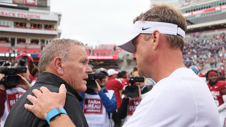Arkansas Razorbacks coach Sam Pittman shakes hands with Ole Miss Rebels coach Lane Kiffin after the game at Razorback Stadium.