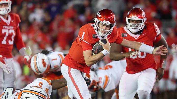 Oct 17, 2026; Houston, Texas, USA; Houston Cougars quarterback Conner Weigman (1) runs with the ball for a first down as Oklahoma State Cowboys defensive tackle Saadiq Clements (5) attempts to make a tackle during the fourth quarter at TDECU Stadium. Mandatory Credit: Troy Taormina-Imagn Images Oct 17, 2026; Houston, Texas, USA; Houston Cougars quarterback Conner Weigman (1) runs with the ball for a first down as Oklahoma State Cowboys defensive tackle Saadiq Clements (5) attempts to make a tackle during the fourth quarter at TDECU Stadium. Mandatory Credit: Troy Taormina-Imagn Images