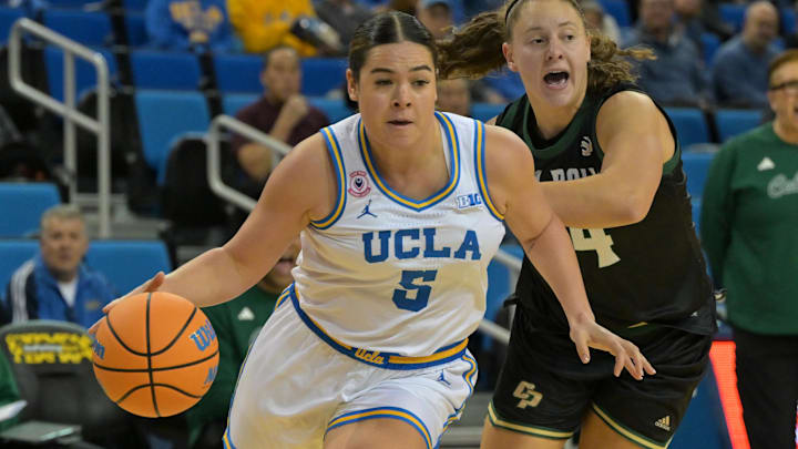 Dec 16, 2025; Los Angeles, California, USA;  UCLA Bruins guard Charlisse Leger-Walker (5) drives past Cal Poly Mustangs guard Madison Butcher (24) during the first half at Pauley Pavilion presented by Wescom Financial. Mandatory Credit: Jayne Kamin-Oncea-Imagn Images