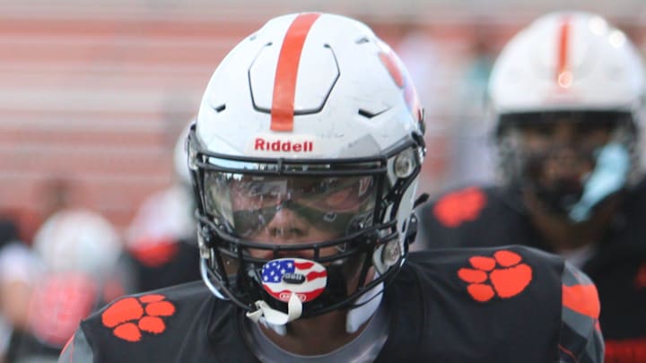 Offensive lineman Jack Carlson of Brighton warms up before a season-opening football game against Dexter on Thursday, Aug. 28, 2025 at Brighton.