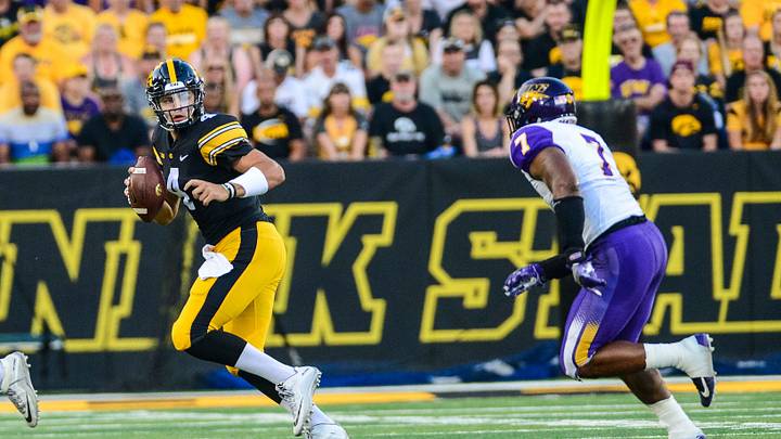 Sep 15, 2018; Iowa City, IA, USA; Iowa Hawkeyes quarterback Nate Stanley (4) runs with the ball as Northern Iowa Panthers linebacker Rickey Neal Jr. (7) looks to make the tackle at Kinnick Stadium. Mandatory Credit: Jeffrey Becker-USA TODAY Sports