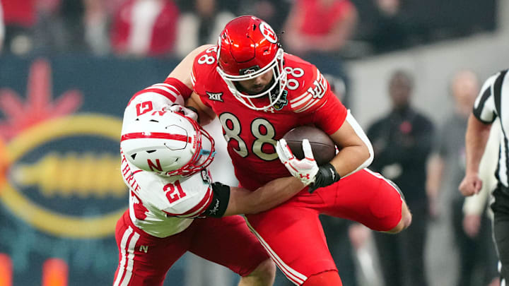 Utah Utes tight end Dallen Bentley carries the ball against Nebraska Cornhuskers defensive back Rex Guthrie. Utah Utes tight end Dallen Bentley carries the ball against Nebraska Cornhuskers defensive back Rex Guthrie.