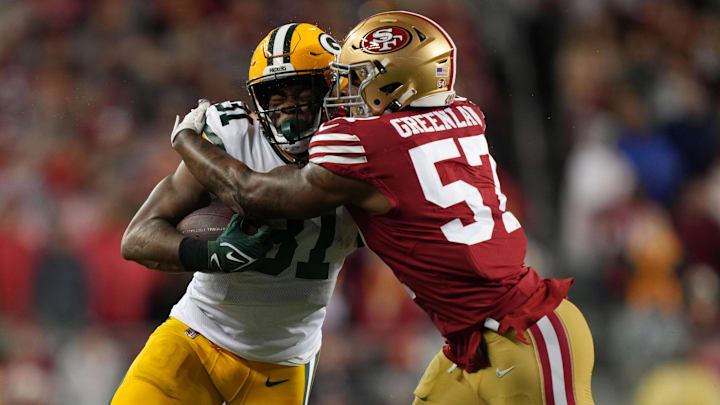 January 20, 2024; Santa Clara, CA, USA; San Francisco 49ers linebacker Dre Greenlaw (57) tackles Green Bay Packers running back Emanuel Wilson (31) during the first quarter in a 2024 NFC divisional round game at Levi's Stadium.