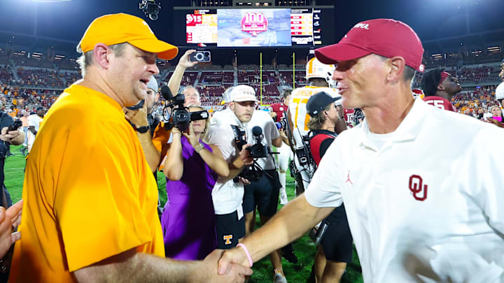 Tennessee coach Josh Heupel (left) shakes hands with Oklahoma's Brent Venables.