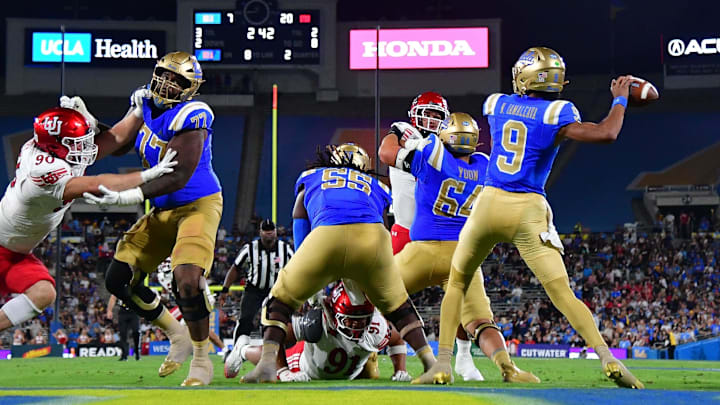 Aug 30, 2025; Pasadena, California, USA; UCLA Bruins quarterback Nico Iamaleava (9) throws as offensive lineman Courtland Ford (77) provides coverage against Utah Utes defensive end John Henry Daley (90) during the first half at Rose Bowl. Mandatory Credit: Gary A. Vasquez-Imagn Images Aug 30, 2025; Pasadena, California, USA; UCLA Bruins quarterback Nico Iamaleava (9) throws as offensive lineman Courtland Ford (77) provides coverage against Utah Utes defensive end John Henry Daley (90) during the first half at Rose Bowl. Mandatory Credit: Gary A. Vasquez-Imagn Images