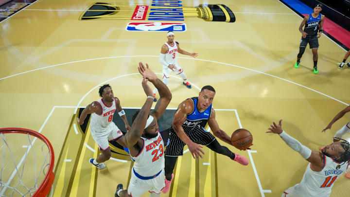 Dec 13, 2025; Las Vegas, Nevada, USA; Orlando Magic guard Desmond Bane (3) drives to the basket on New York Knicks center Mitchell Robinson (23) and guard Jalen Brunson (11) during a game at T-Mobile Arena. Mandatory Credit: Kirby Lee-Imagn Images Dec 13, 2025; Las Vegas, Nevada, USA; Orlando Magic guard Desmond Bane (3) drives to the basket on New York Knicks center Mitchell Robinson (23) and guard Jalen Brunson (11) during a game at T-Mobile Arena. Mandatory Credit: Kirby Lee-Imagn Images