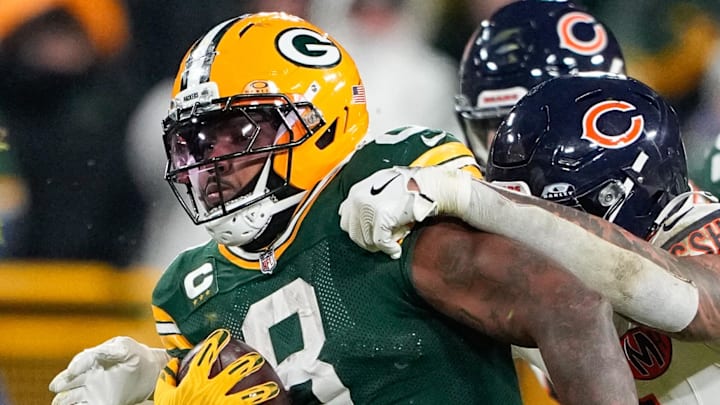Green Bay Packers running back Josh is tackled by Chicago Bears defensive lineman Austin Booker. Green Bay Packers running back Josh is tackled by Chicago Bears defensive lineman Austin Booker.