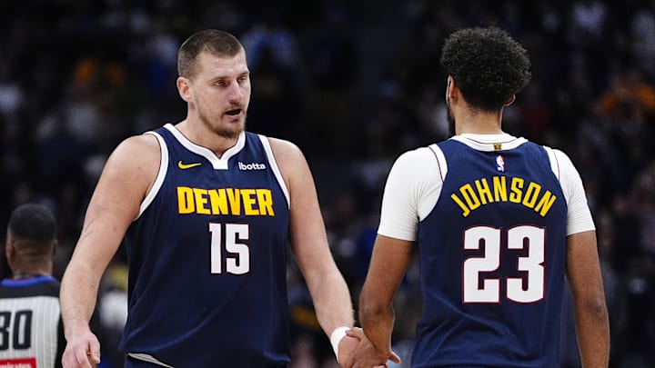 Dec 15, 2025; Denver, Colorado, USA; Denver Nuggets forward Cameron Johnson (23) and center Nikola Jokic (15) in the second quarter against the Houston Rockets at Ball Arena.