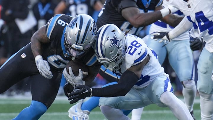 Nov 19, 2023; Charlotte, North Carolina, USA; Carolina Panthers running back Miles Sanders (6) is tackled near the goal line by Dallas Cowboys safety Malik Hooker (28) during the second half at Bank of America Stadium. Mandatory Credit: Jim Dedmon-Imagn Images
