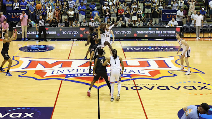Nov 25, 2024; Lahaina, Hawaii, USA;  The Memphis Tigers guard Colby Rogers (3) get the ball over the Connecticut Huskies at the start of the first half of an NCAA college basketball game at Lahaina Civic Center. Mandatory Credit: Marco Garcia-Imagn Images