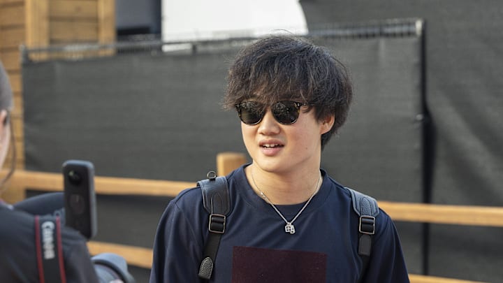 Oct 22, 2023; Austin, Texas, USA; Scuderia Alpha Tauri driver Yuki Tsunoda (22) of Team Japan walks into the track entrance before the start of the 2023 United States Grand Prix at Circuit of the Americas. Mandatory Credit: Jerome Miron-Imagn Images