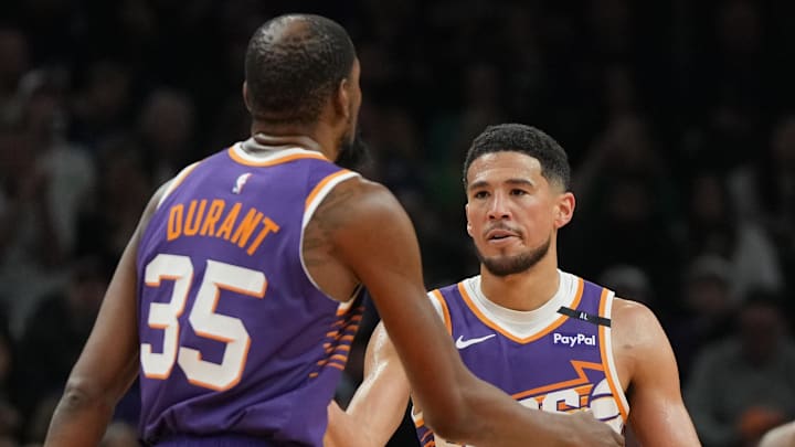 Mar 17, 2025; Phoenix, Arizona, USA; Phoenix Suns forward Kevin Durant (35) celebrates with guard Devin Booker (1) after scoring against the Toronto Raptors in the first half at Footprint Center. Mandatory Credit: Rick Scuteri-Imagn Images