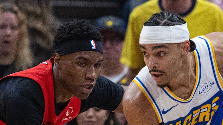 Indiana Pacers guard/forward Andrew Nembhard holds the ball while Toronto Raptors guard Ja'Kobe Walter defends. Indiana Pacers guard/forward Andrew Nembhard holds the ball while Toronto Raptors guard Ja'Kobe Walter defends.
