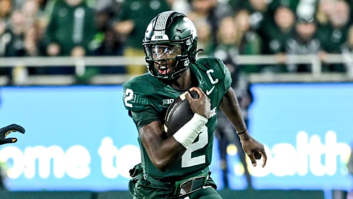 Michigan State's Aidan Chiles, right, runs for a big gain as Iowa's Koen Entringer follows behind during the third quarter on Saturday, Oct. 19, 2024, at Spartan Stadium in East Lansing.