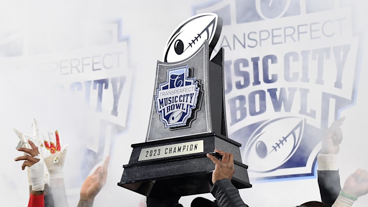 Dec 30, 2023; Nashville, TN, USA; Maryland Terrapins head coach Mike Locksley celebrates with the championship trophy after a win against the Auburn Tigers at Nissan Stadium. Mandatory Credit: Christopher Hanewinckel-Imagn Images Dec 30, 2023; Nashville, TN, USA; Maryland Terrapins head coach Mike Locksley celebrates with the championship trophy after a win against the Auburn Tigers at Nissan Stadium. Mandatory Credit: Christopher Hanewinckel-Imagn Images