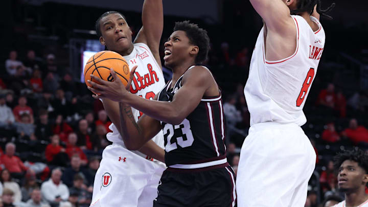 Mississippi State Bulldogs guard King Grace (23) goes to the basket against Utah Utes forward Kendyl Sanders (13) and forward Keanu Dawes (8) during the first half at Delta Center.