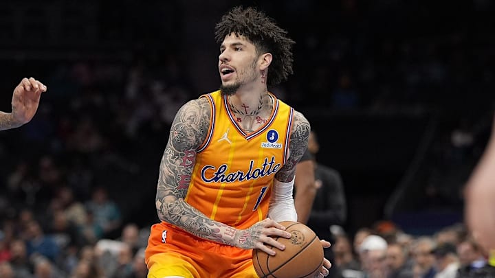 Nov 29, 2025; Charlotte, North Carolina, USA; Charlotte Hornets guard LaMelo Ball (1) looks to pass defended by Toronto Raptors forward Brandon Ingram (3) during the first quarter at Spectrum Center. Mandatory Credit: Jim Dedmon-Imagn Images