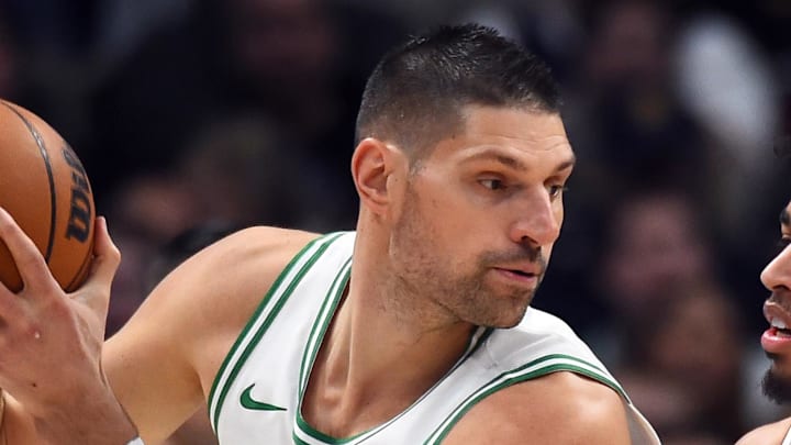 Feb 25, 2026; Denver, Colorado, USA; Boston Celtics center Nikola Vucevic (4) works in the post against Denver Nuggets guard Julian Strawther (3) during the first half at Ball Arena. Mandatory Credit: Christopher Hanewinckel-Imagn Images