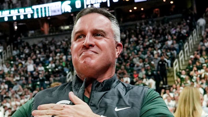 Michigan State's new football coach Pat Fitzgerald pats his heart at the crowd in attendance for the Spartans basketball game against Iowa on Tuesday, Dec. 2, 2025, at the Breslin Center in East Lansing.