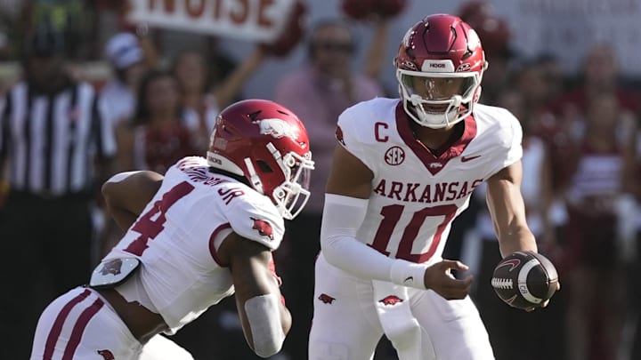 Arkansas Razorbacks quarterback Taylen Green (10) hands the ball off to running back Mike Washington Jr. (4) during the first half against the Texas Longhorns at Darrell K Royal-Texas Memorial Stadium.
